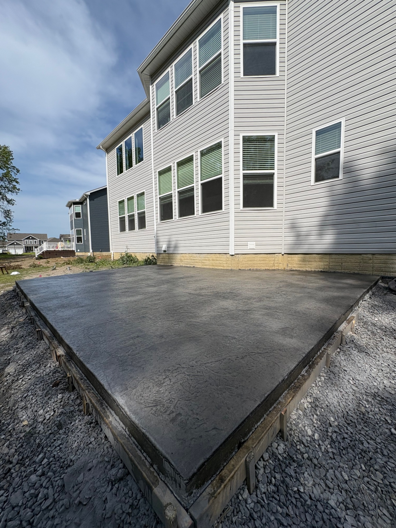 Large broom-finished concrete patio installation at a Hinckley, Ohio home