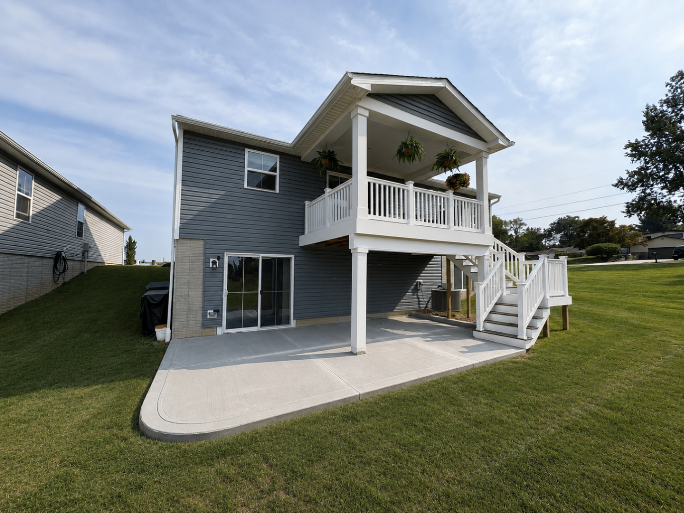 Concrete patio installation beneath a covered second-story deck at an Akron, Ohio home by Edgewater Company