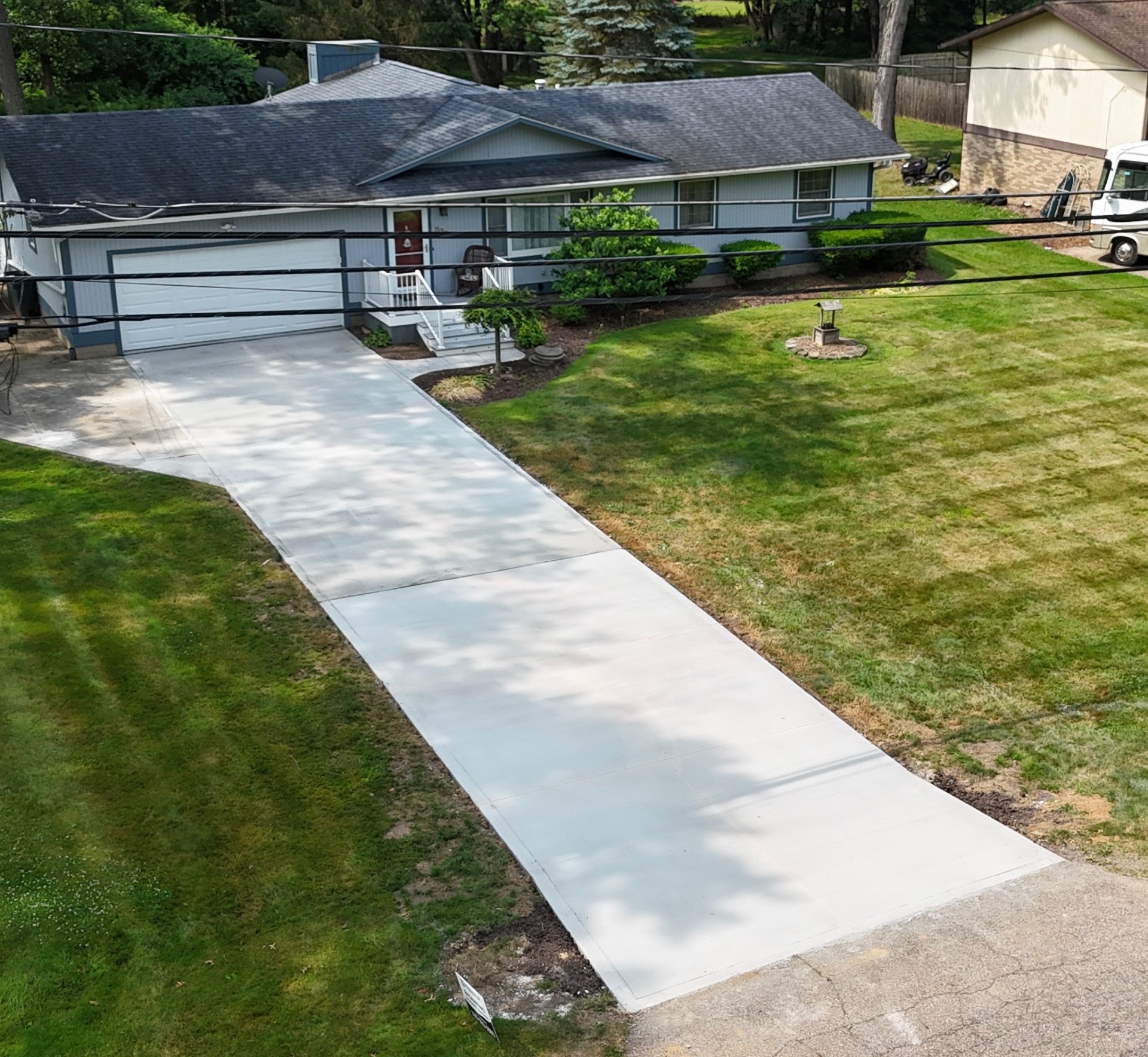 Aerial view of a new residential concrete driveway installation at a Bath, Ohio home by Edgewater Company