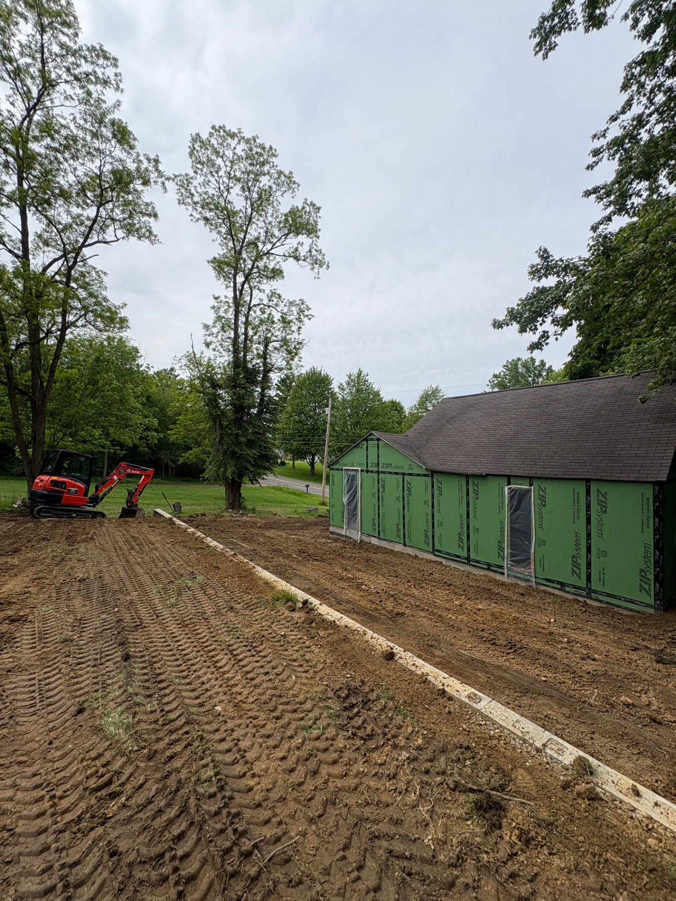Excavation and grade preparation alongside a new outbuilding project in Akron, Ohio