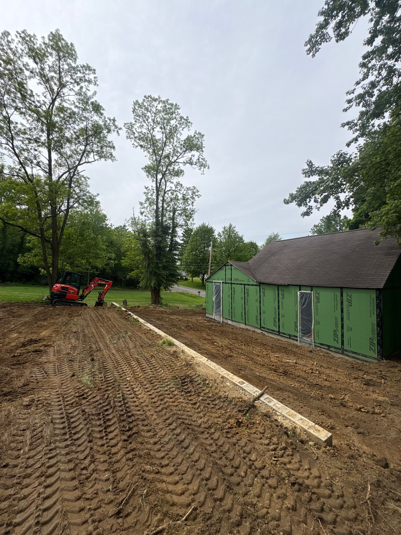 Site preparation and grade work for a garage pad next to an outbuilding in Akron, Ohio