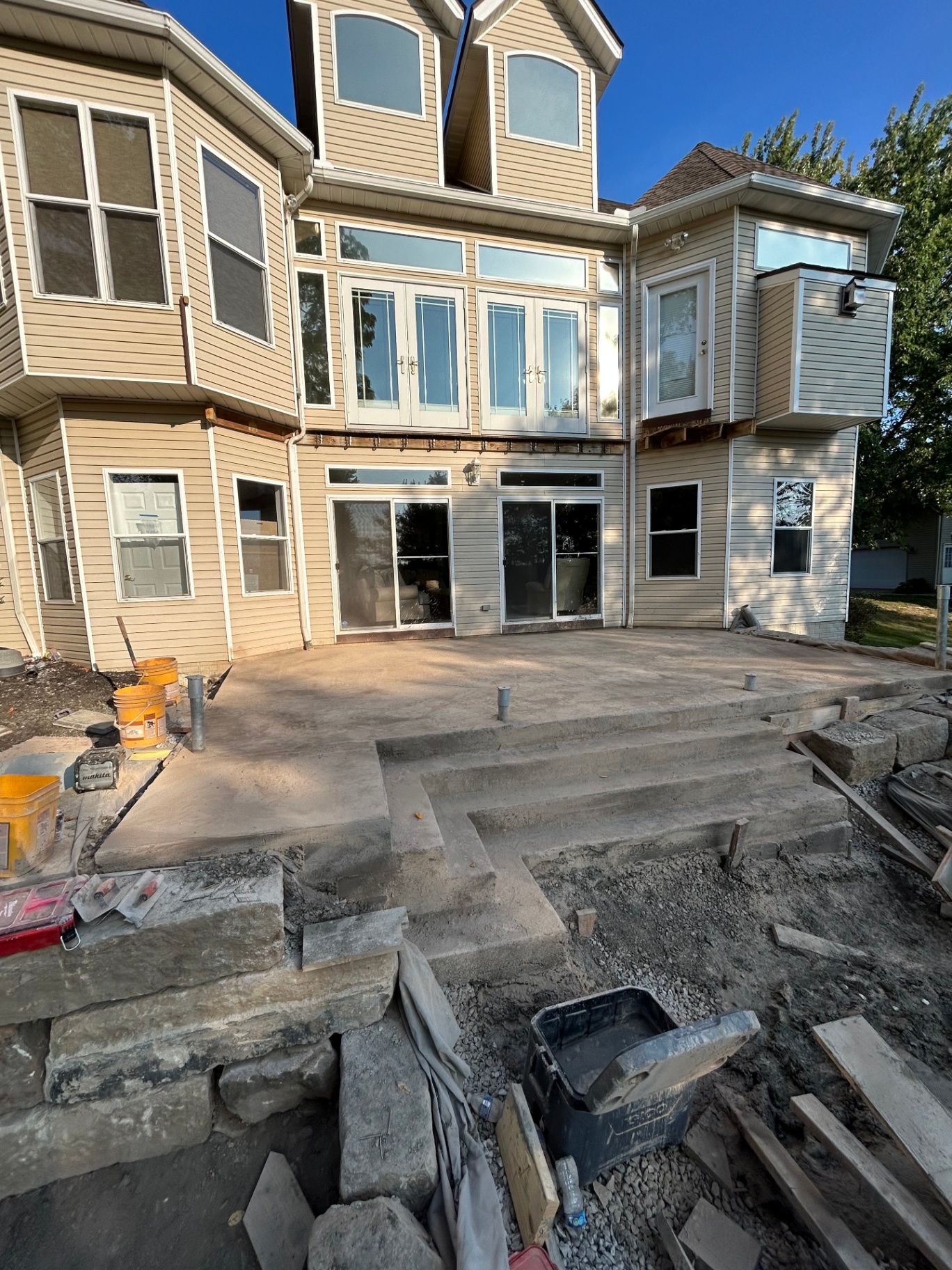 Concrete patio and step installation at the back of an Avon, Ohio home