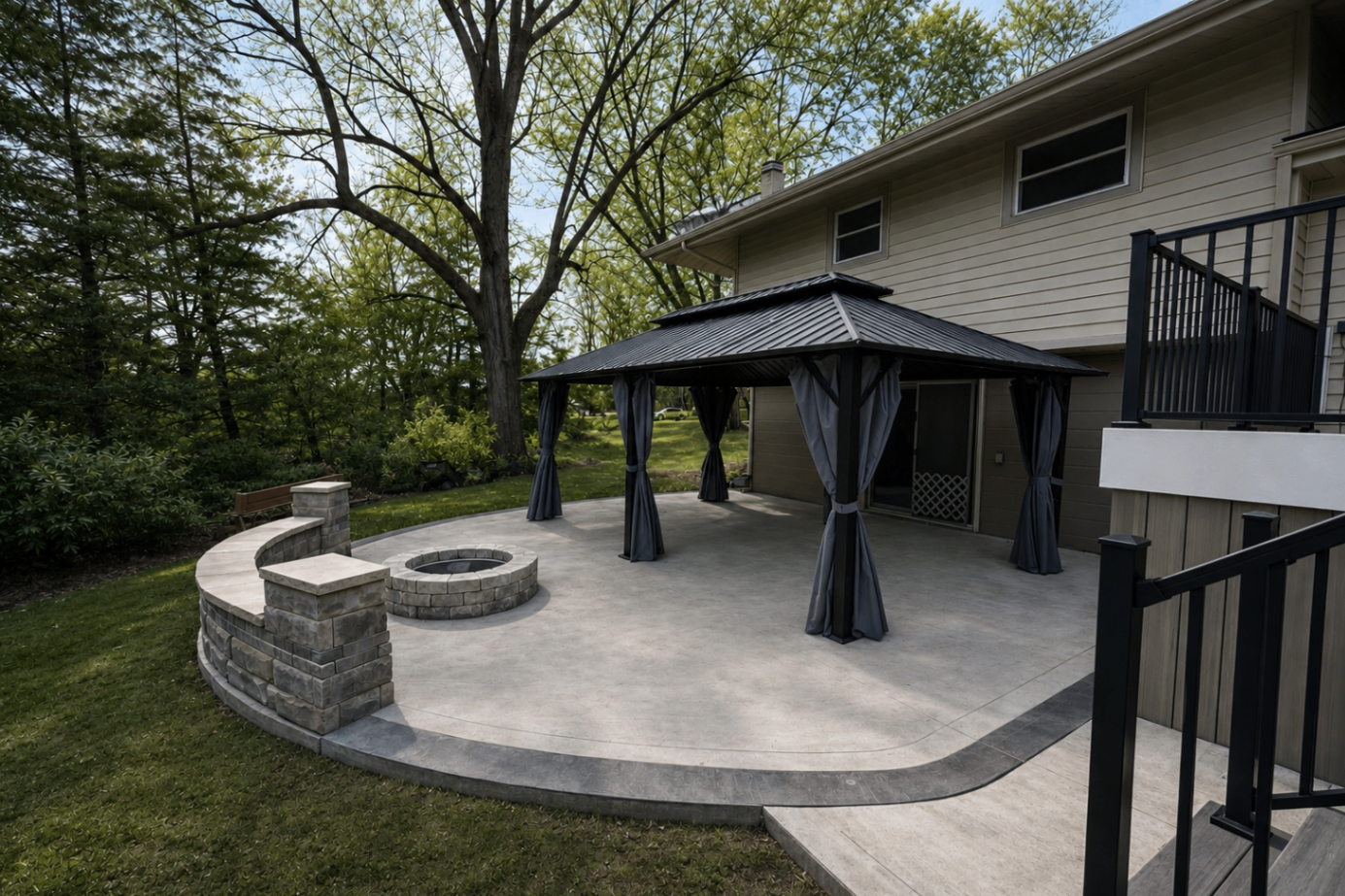 Stamped concrete patio with stone fire pit and gazebo at a Medina, Ohio backyard by Edgewater Company